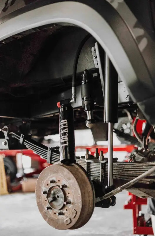 Close-up of 2.5-inch smooth body shock mounted on a vehicle's suspension system, highlighting its robust design and functionality.