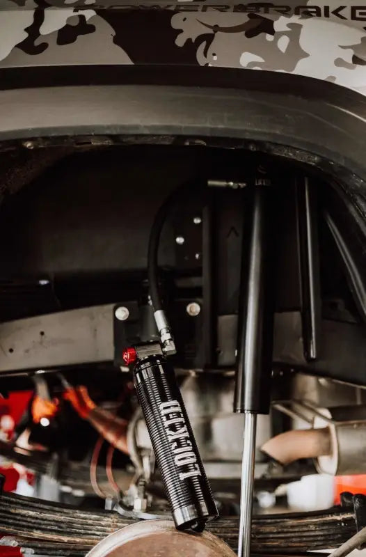 2.5-inch smooth body shock with external reservoir installed on a vehicle, emphasizing off-road performance and durability.