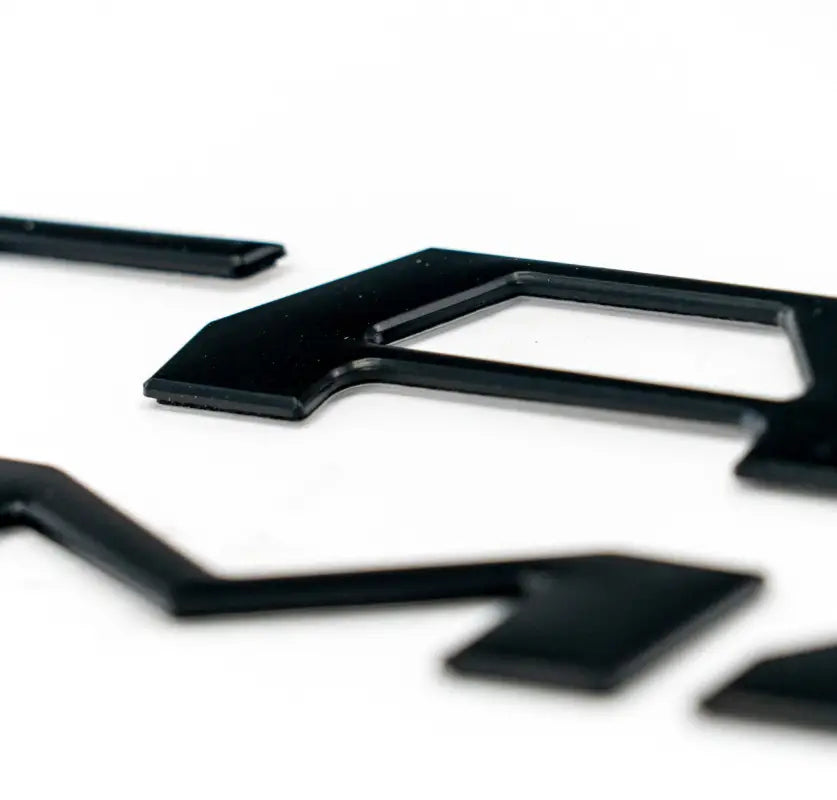 Black cutout letters on 2016-23 Tacoma Tailgate Inserts for custom color and route protection