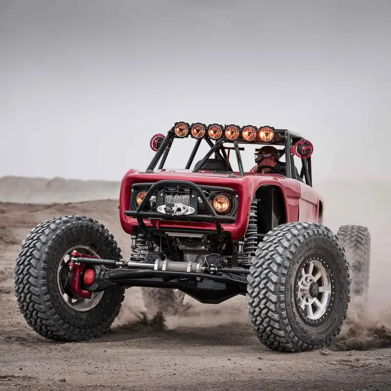 Close-up of red off-road vehicle with Titan™ LED Light Bar, showcasing its bright lights and rugged build.