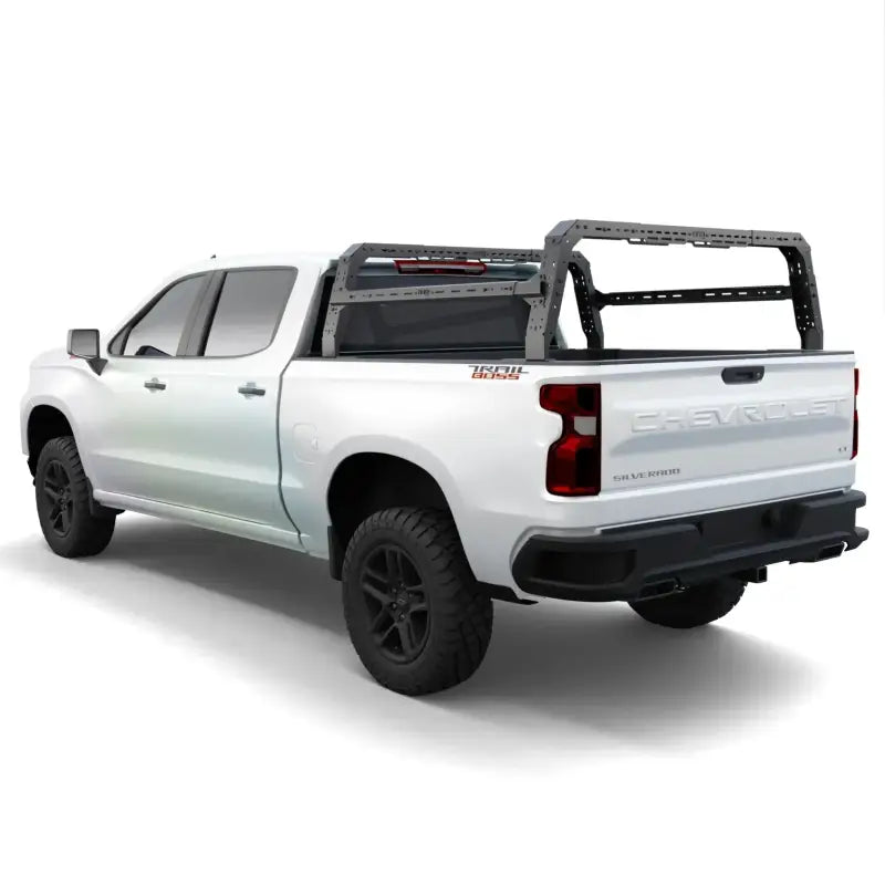 Rear view of GMC Sierra 4CX bed rack on a white truck, showcasing its sturdy design for cargo and overlanding needs.