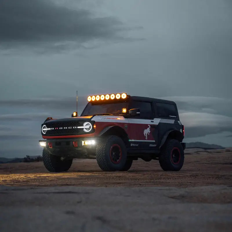 Ford Bronco equipped with the 50-inch Gravity Titan LED Light Bar, parked in a desert landscape during dusk.