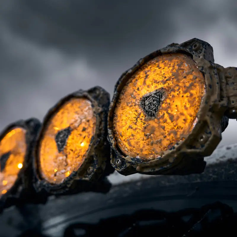 Close-up of the 50-inch Gravity Titan LED Light Bar covered in mud, showcasing its rugged durability and amber lighting.