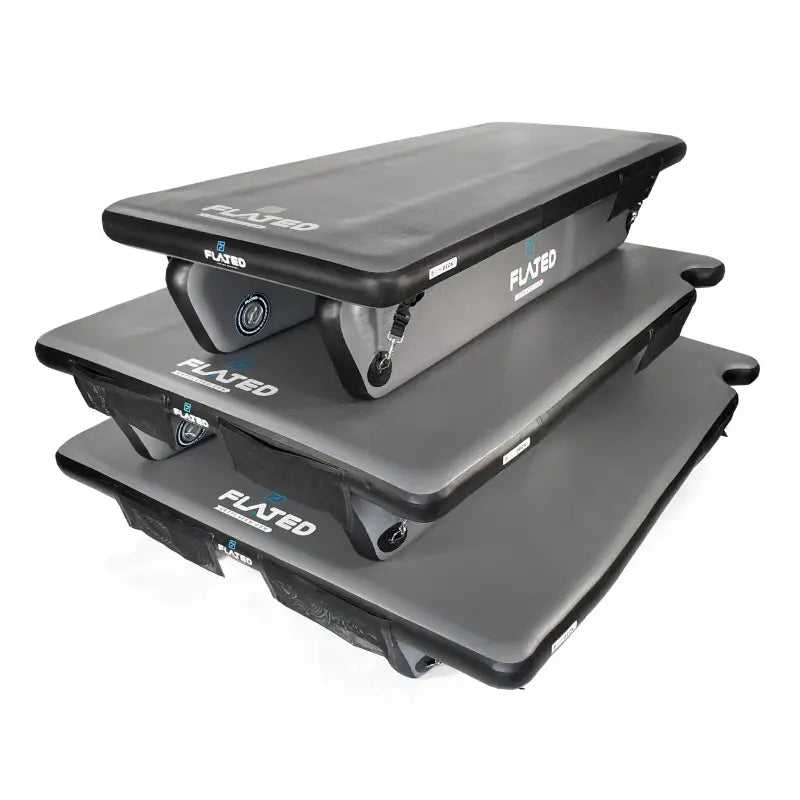 Stacked 6' Cot - Portable Air-Deck units, showcasing their compact storage and versatility for various vehicle and outdoor needs.