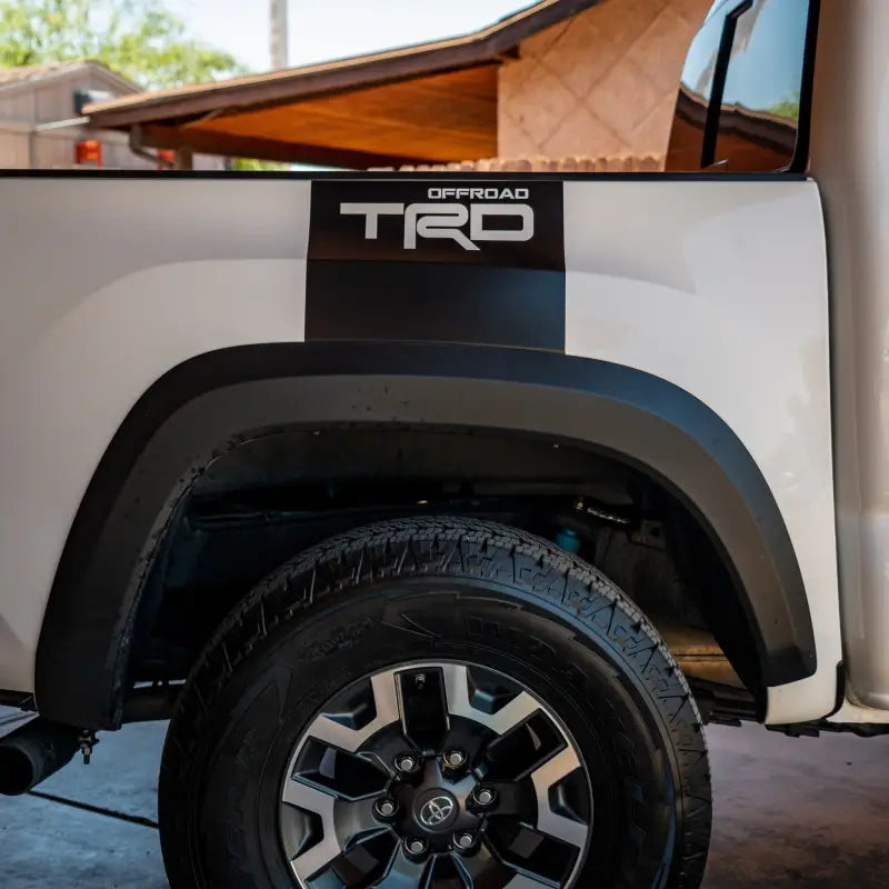 White truck with black TRD decal showing Alpha Bed Decals for enhanced truck bed style