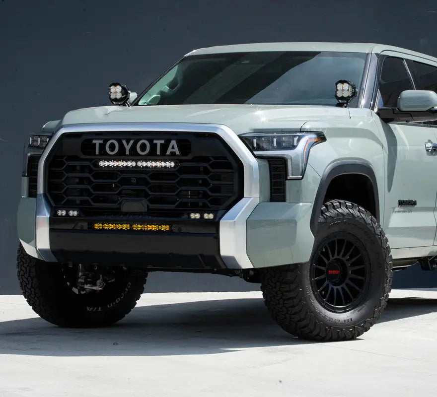 Modified light green Toyota Tundra with Baja Designs S8 20’’ TRD Pro grille conversion kit and light bar