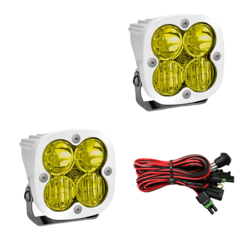 Baja Designs Squadron Pro LED light pods in white housing with amber lenses, offering waterproof design and wiring harness.