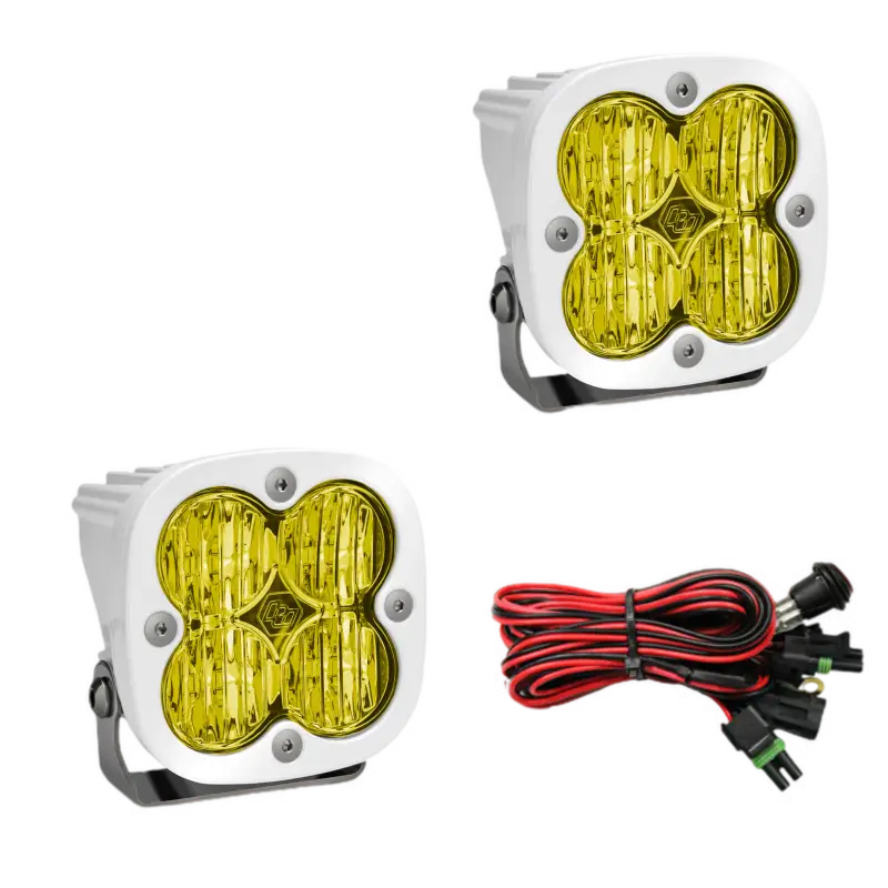 Baja Designs Squadron Pro LED light pods in white housing with amber lenses, featuring waterproof construction and wiring harness.