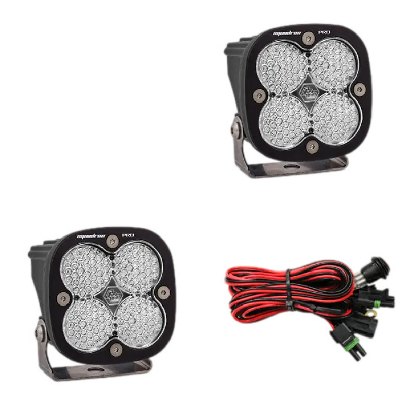 Baja Designs Squadron Pro LED light pods in black housing with clear lenses, showcasing durable construction and wiring harness.