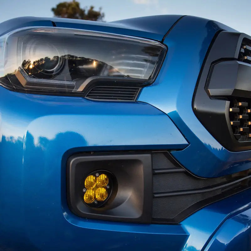 Blue truck front end with Baja Designs Squadron-R Sport fog pocket kit for Toyota Tacoma