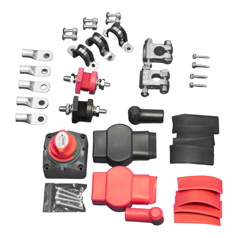Close-up of components in the Toyota Tacoma battery relocate kit, including terminals, clamps, and protective covers.