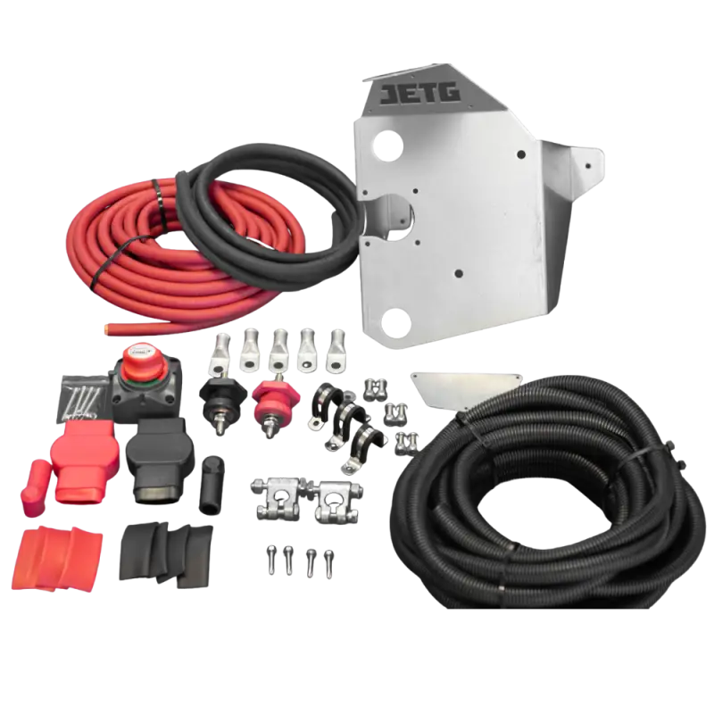 Complete Toyota Tacoma 2005-2023 battery relocate kit by JETG Designs, featuring cables, mounting bracket, terminals, and hardware.