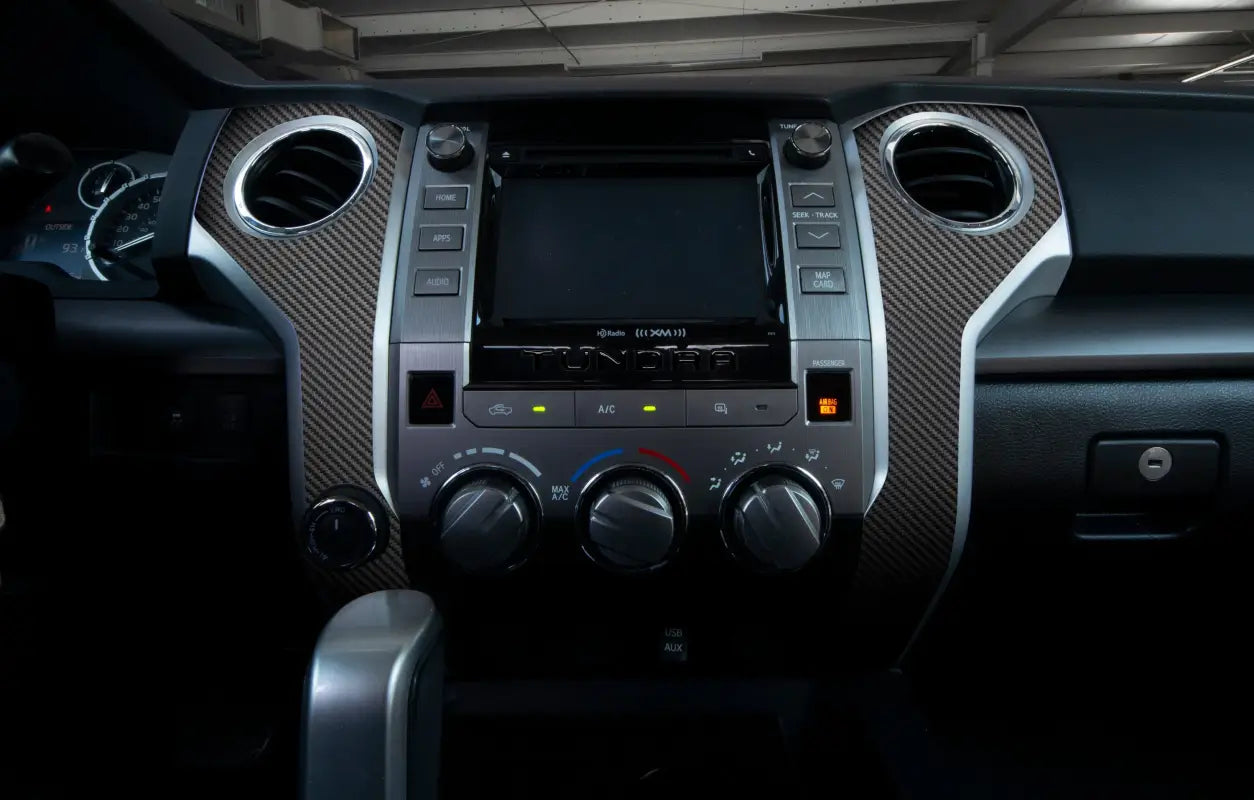 Close-up of carbon fiber-style bezel accent trim installed on a 2014-2021 Toyota Tundra dashboard, highlighting premium finish.