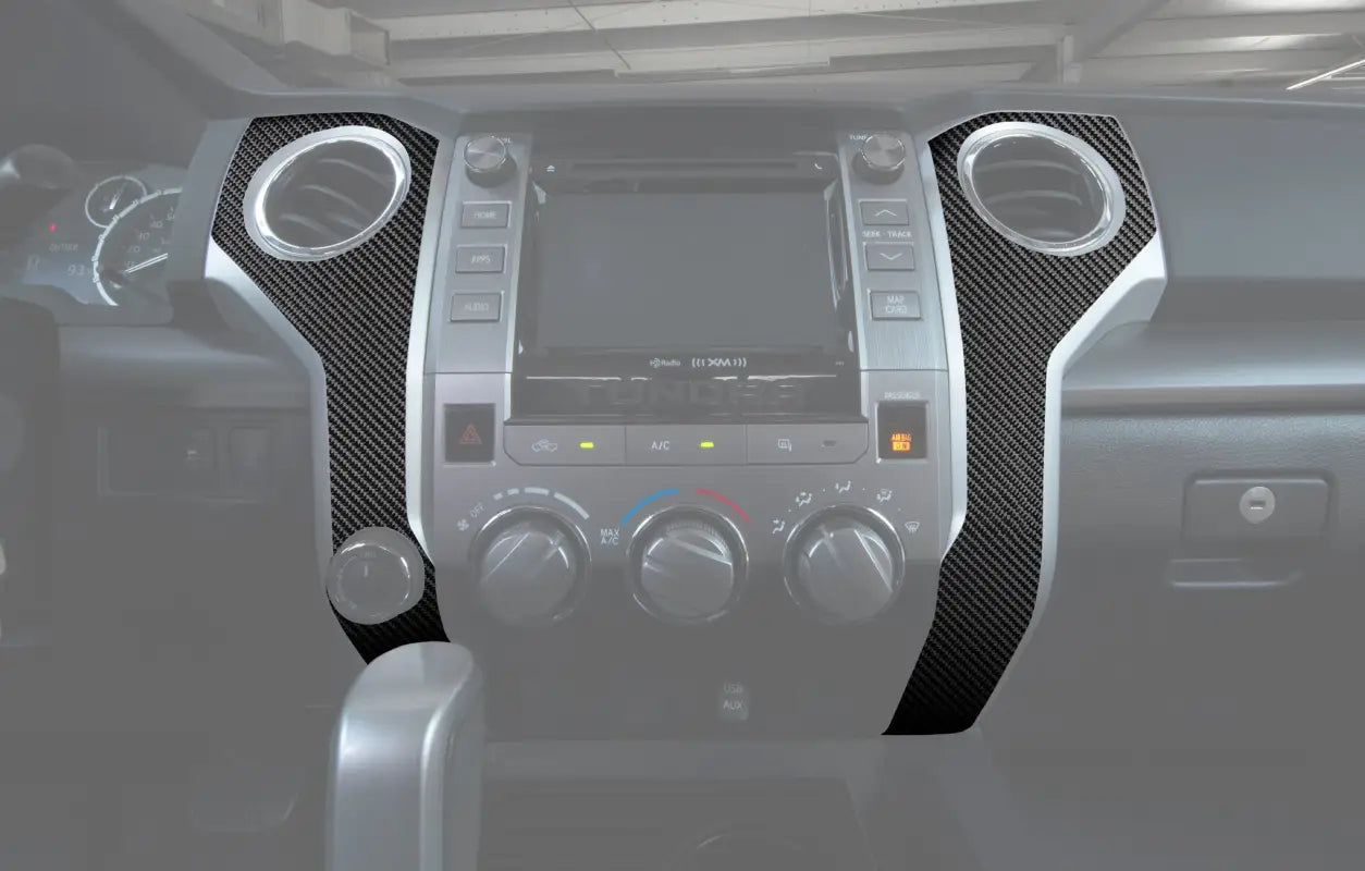 Bezel accent trim with carbon fiber texture installed on the dashboard of a 2014-2021 Toyota Tundra, enhancing interior style.