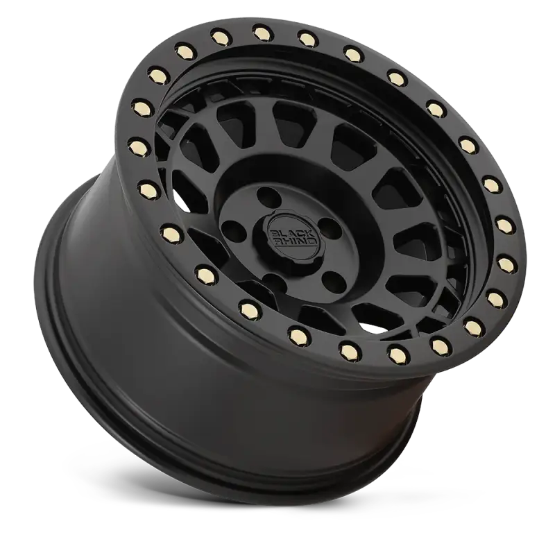 Angled view of Black Rhino PRIMM matte black wheel with gold rivets, showcasing its rugged multi-spoke design for off-road vehicles.