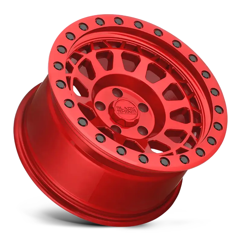 Angled view of Black Rhino PRIMM gloss red wheel with black rivets, showcasing its striking design for rugged and street-legal vehicles.