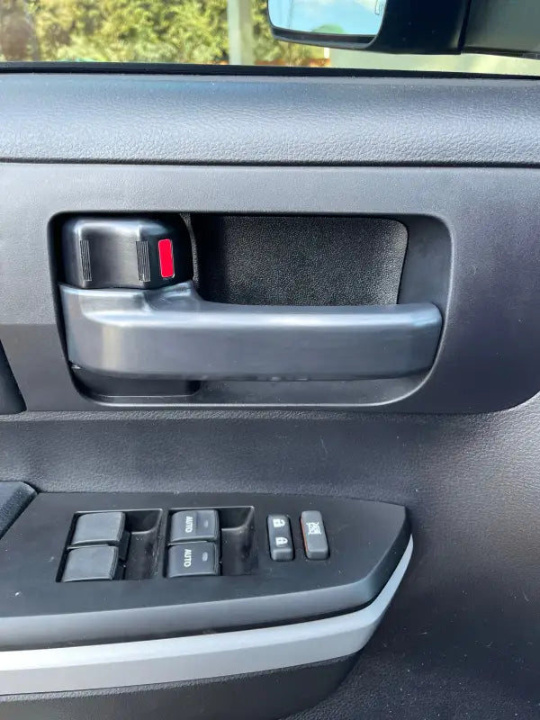 Installed Tundra blackout door handle cover on a Toyota Tundra interior door panel, blending seamlessly with the factory design for a sleek look.