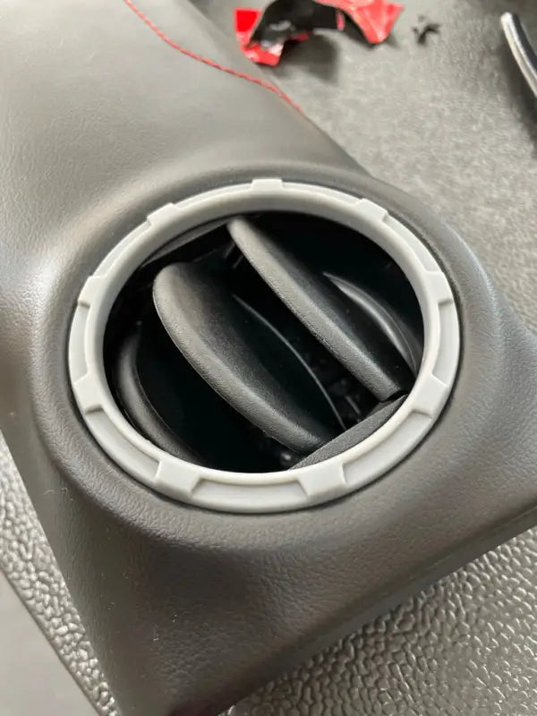 Gray vent ring installed on a dashboard panel, showcasing its fit and compatibility with Tundra interiors.