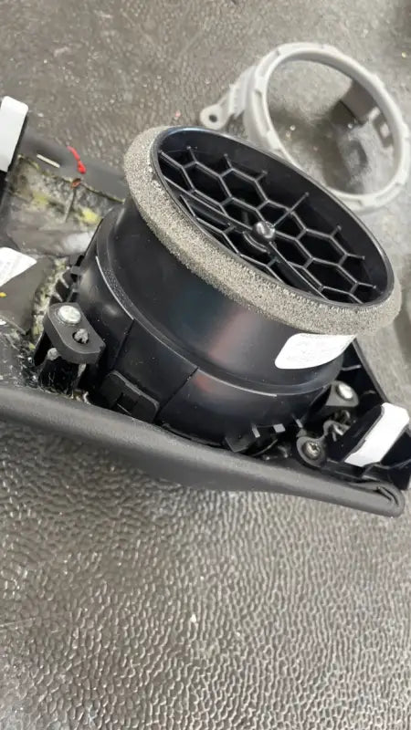 Disassembled vent assembly with a gray vent ring, demonstrating the installation process for Tundra interior upgrades.