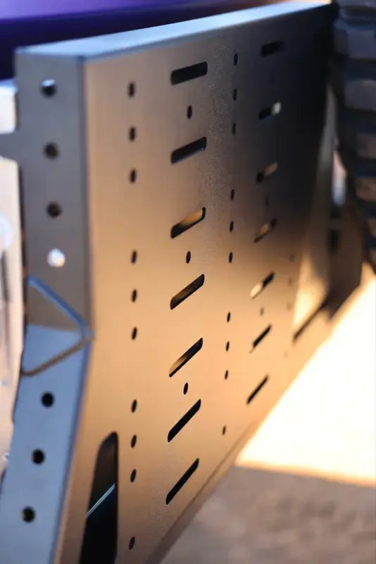 Detailed view of the Tacoma bolt-on swing out panel with multiple slots for customizable gear mounting options.