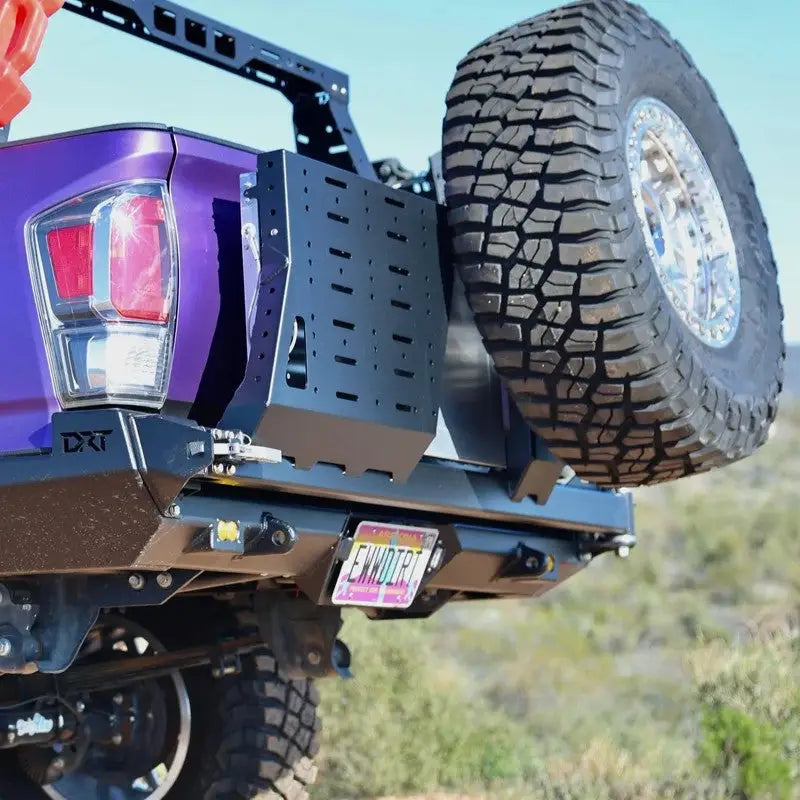 Close-up of Tacoma bolt-on swing out with spare tire mounted on a DRT bumper, showcasing durable construction and design.