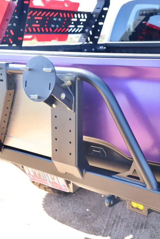 Side view of the Tacoma bolt-on swing out frame, featuring a durable design and adjustable mounting points.