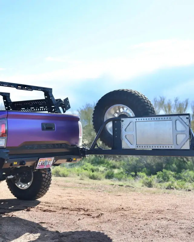 Rear view of the Tacoma bolt-on swing out with spare tire and gear mount extended, showcasing off-road functionality.