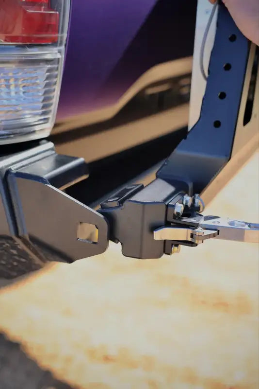 Lockable latch mechanism of the Tacoma bolt-on swing out, designed for secure attachment to the DRT bumper.