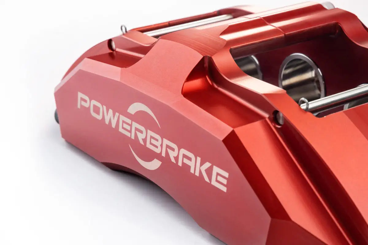 Close-up of red PowerBrake 6-piston caliper with engraved logo, showcasing premium design and durability for 4Runner Big Brake Kit 03-09.