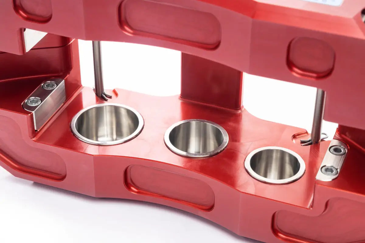 Angled view of red PowerBrake 6-piston caliper, showcasing robust construction for 4Runner Big Brake Kit 03-09.