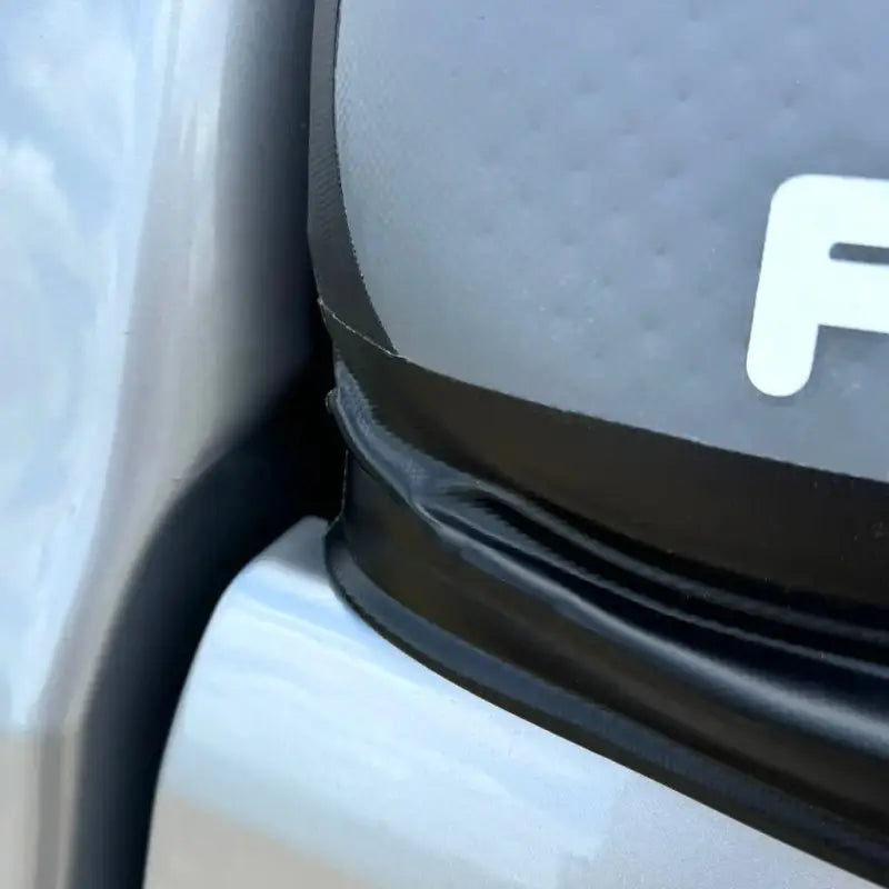 Close-up of the CAP Mid-Size 5' Bed Air-Topper's secure attachment to a truck bed, highlighting its durable and precise fit.