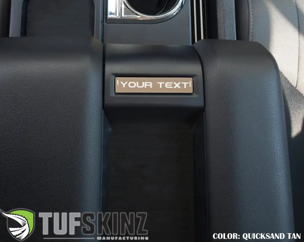 Quicksand tan customizable center console badge installed in a 2014-2021 Toyota Tundra, enhancing interior design.