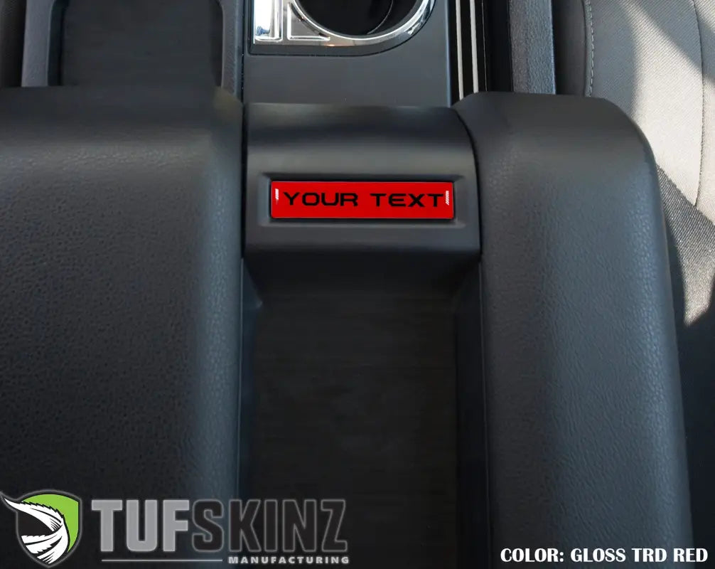 Center console badge in gloss TRD red finish, customizable text, tailored for 2014-2021 Toyota Tundra interior enhancement.