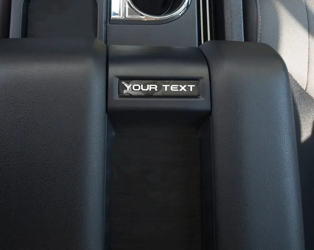 Lunar rock customizable center console badge installed in a 2014-2021 Toyota Tundra, enhancing interior aesthetics with a distinctive look.