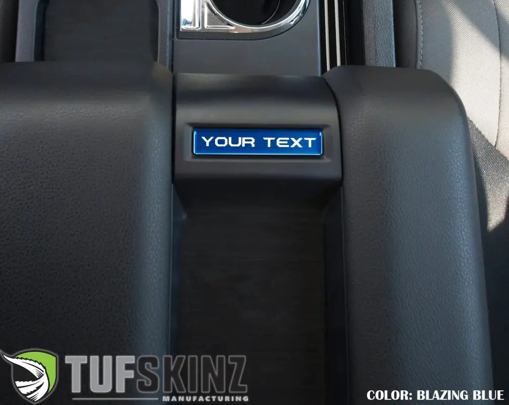 Blazing blue customizable center console badge installed in a 2014-2021 Toyota Tundra, enhancing interior aesthetics.