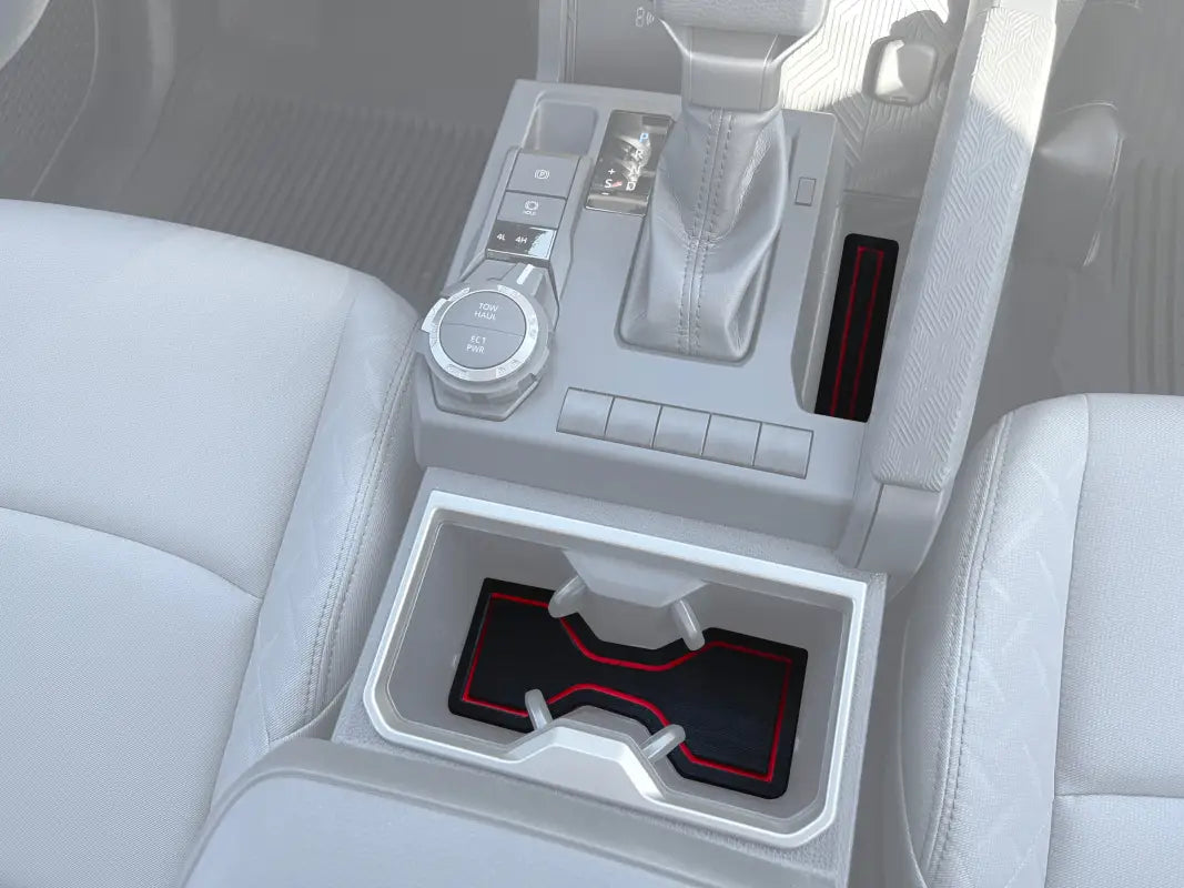 Center console and cup holder foam inserts with red accents installed in a 2024-2025 Toyota Tacoma interior for added protection and style.