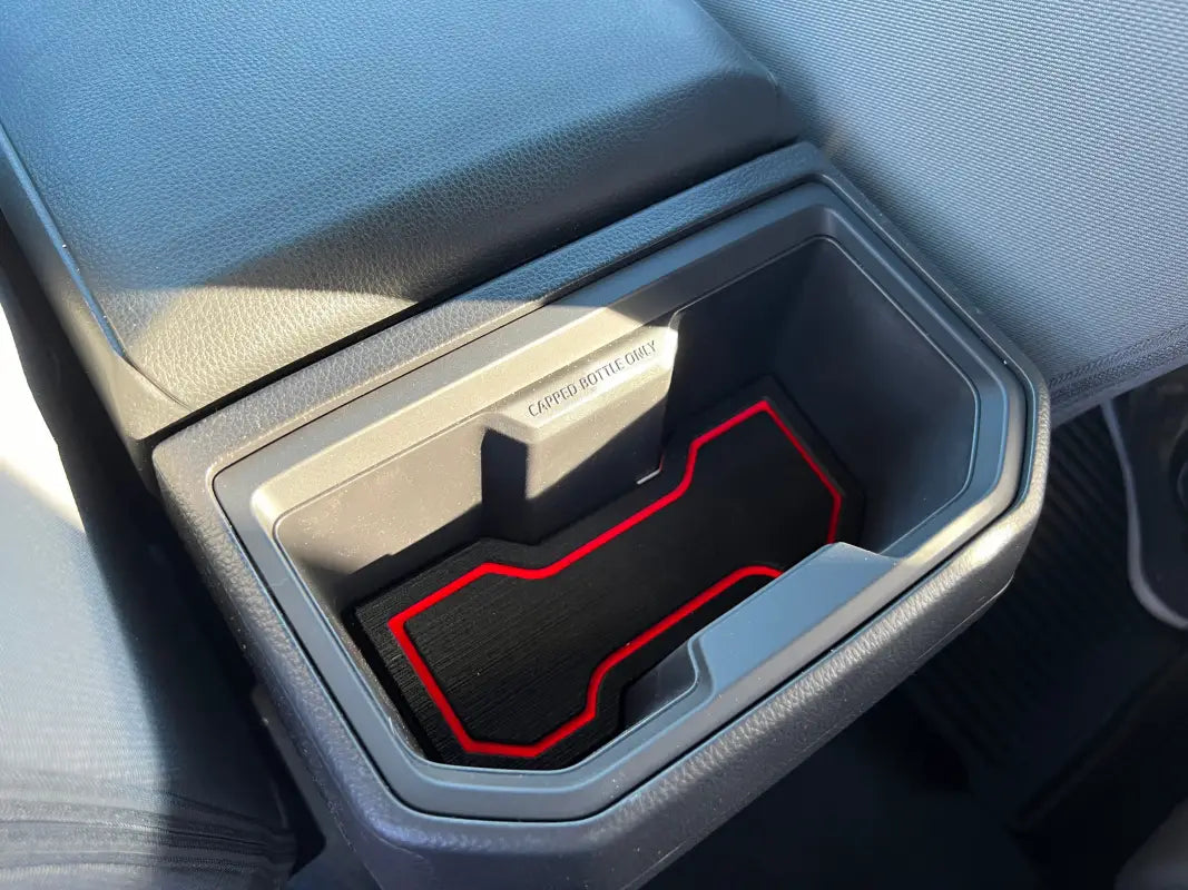 Detailed view of cup holder foam insert with red accents installed in a 2024-2025 Toyota Tacoma, providing a custom fit and stylish protection.