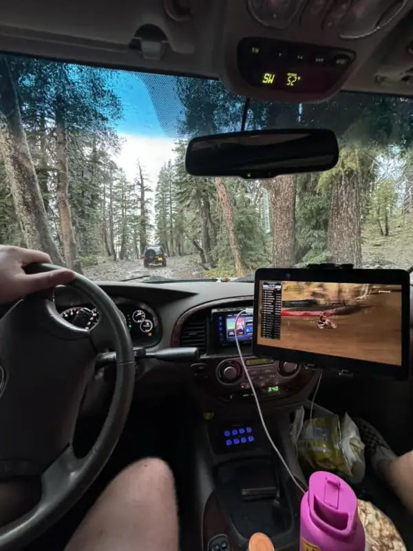 Interior view of a Sequoia with modular accessory mount holding a tablet and phone during an off-road adventure.