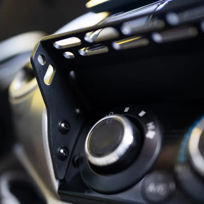Close-up of the Tacoma modular accessory mount's mounting holes and hardware, showcasing its robust design.