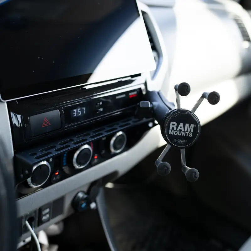 Tacoma modular accessory mount with a RAM X-Grip phone holder attached, offering secure and accessible phone placement.