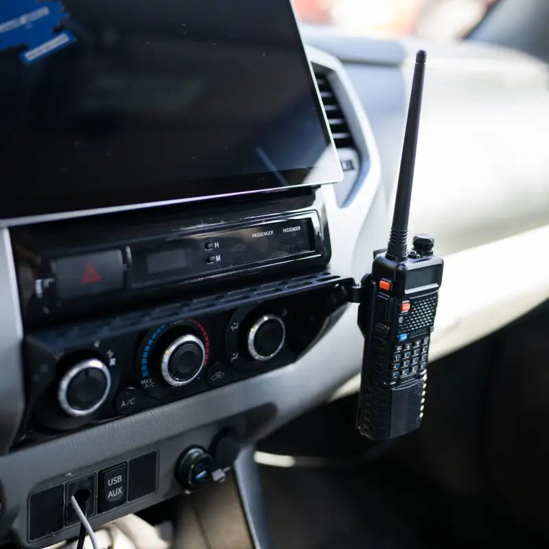 Tacoma modular accessory mount with a mounted two-way radio, highlighting its versatility for off-road communication.