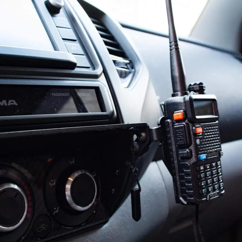 Tacoma modular accessory mount with a two-way radio securely attached, ideal for off-road communication needs.