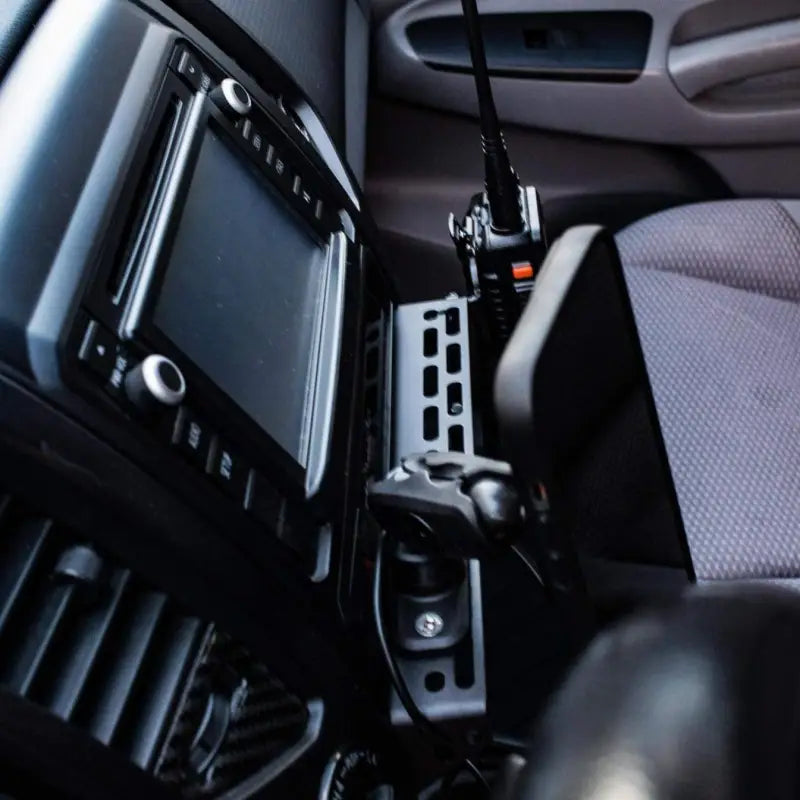 Top-down view of the Tacoma modular accessory mount with multiple attachments, including a phone holder and radio mount.