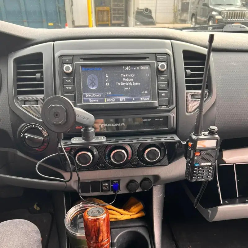 Tacoma modular accessory mount holding a phone mount and two-way radio, showcasing its multi-functional capabilities.