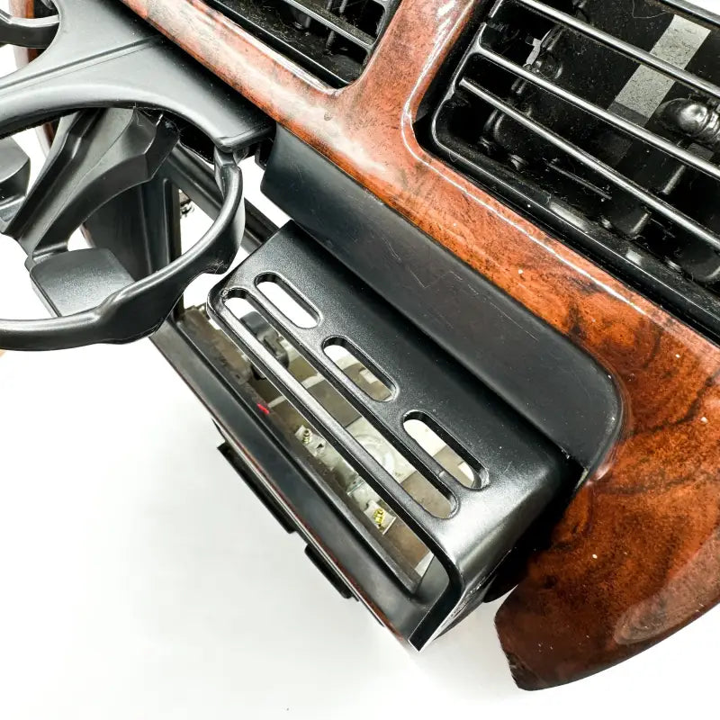 Installed 3rd Gen 4Runner console mount with cup holder and accessory slots, blending seamlessly with the woodgrain dash.