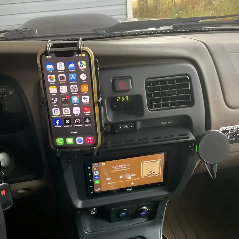 3rd Gen 4Runner console mount holding a smartphone and other accessories, showcasing its practical modular design.