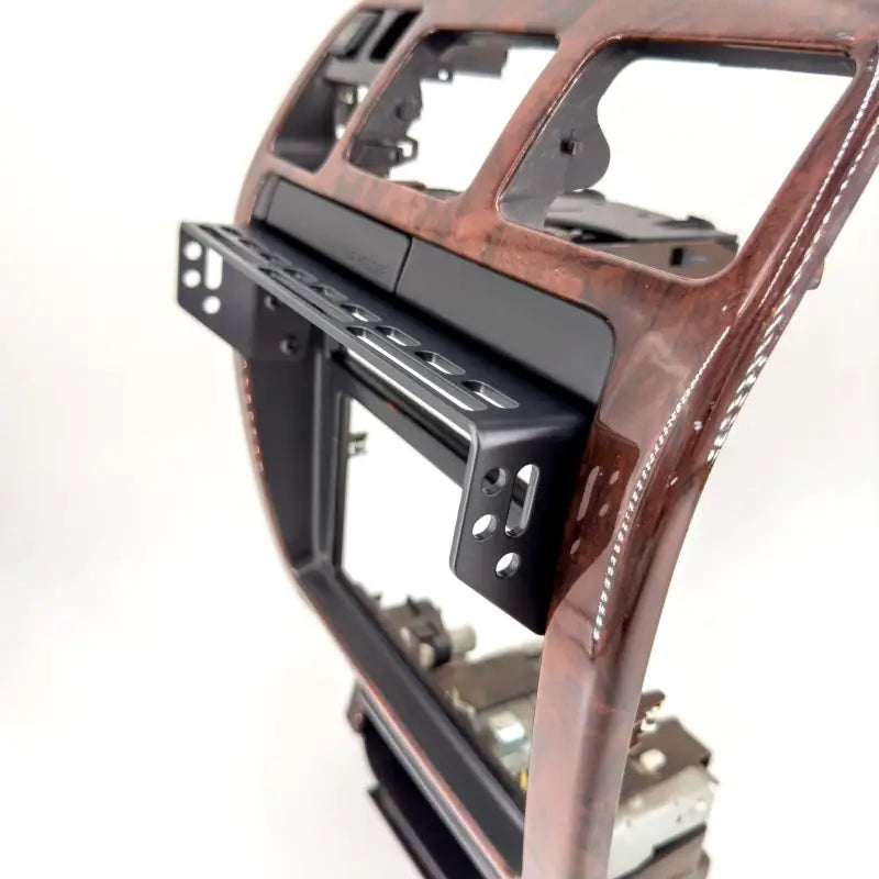 3rd Gen 4Runner modular console mount on a woodgrain dash panel, highlighting accessory slots and sturdy construction.