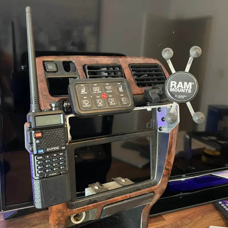 3rd Gen 4Runner console mount setup with radio, phone holder, and switch panel, highlighting its multifunctional use.