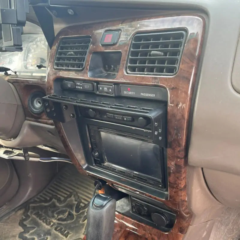 3rd Gen 4Runner console mount installed on a woodgrain dash panel, showcasing its seamless integration and modular design.