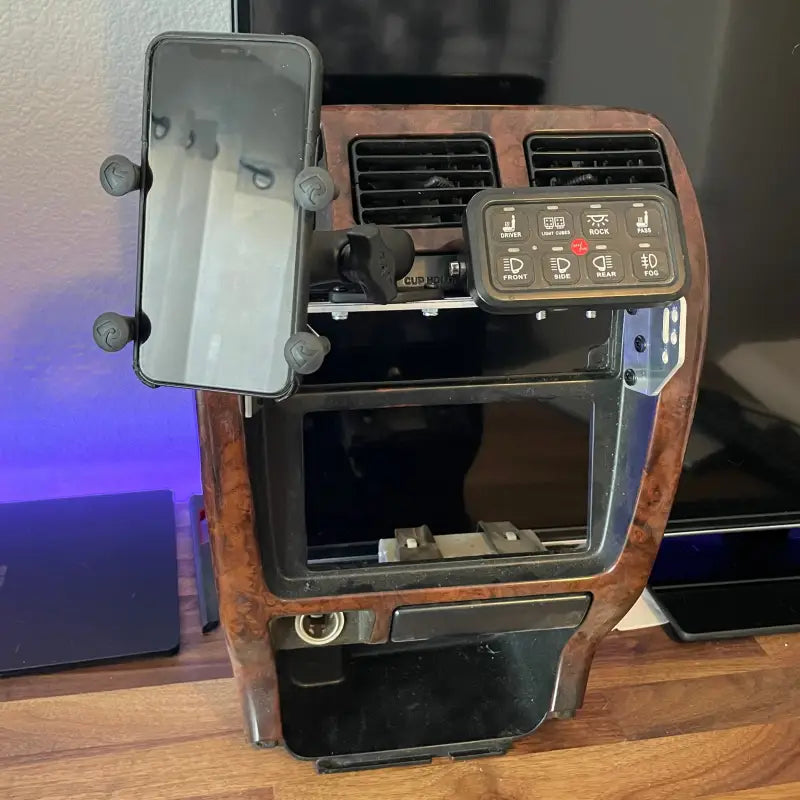 3rd Gen 4Runner console mount with a mounted phone and switch panel, emphasizing its multifunctional and durable design.